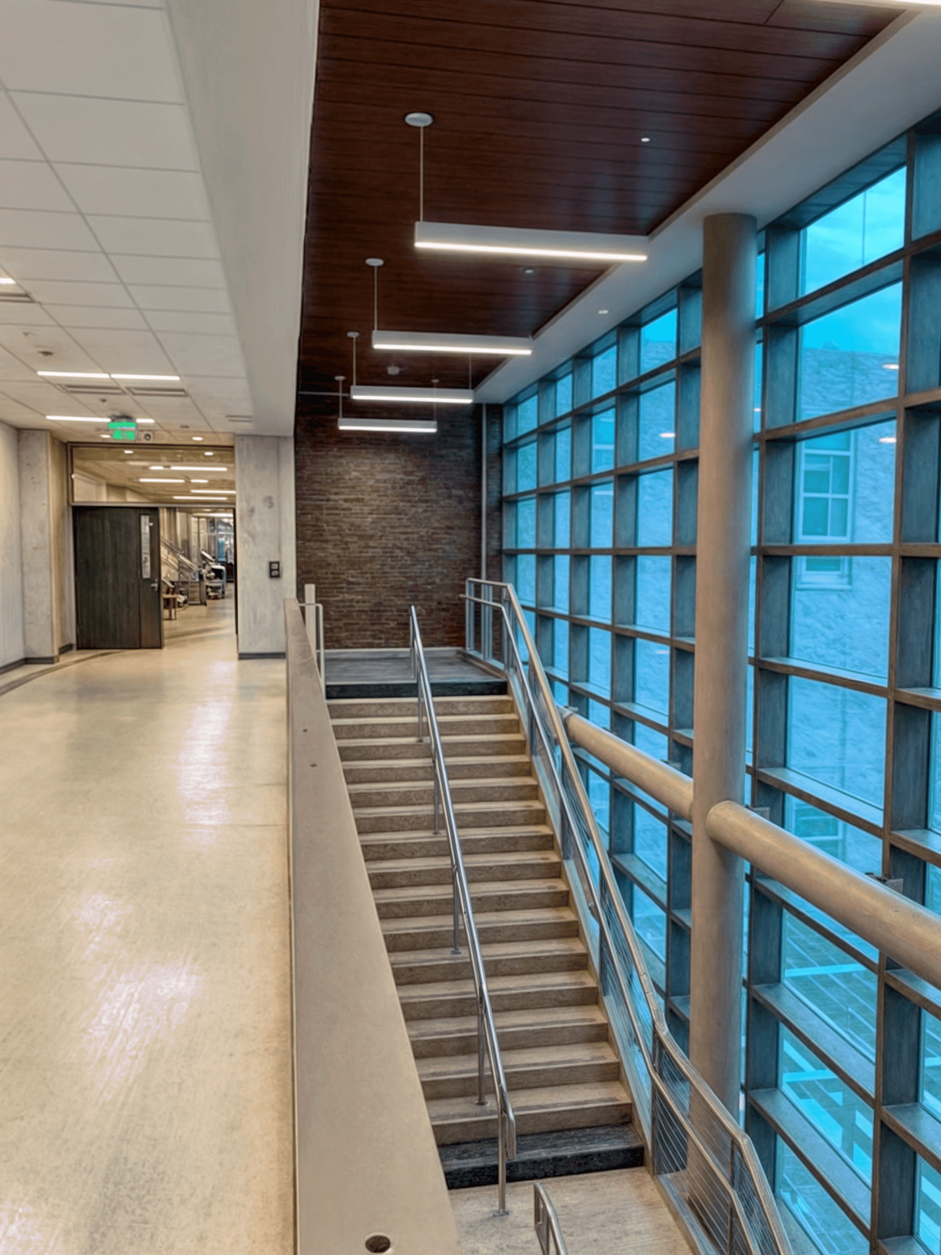 an interior space, a stairwell in a building. The stairs are visible, and there are safety rails on the side